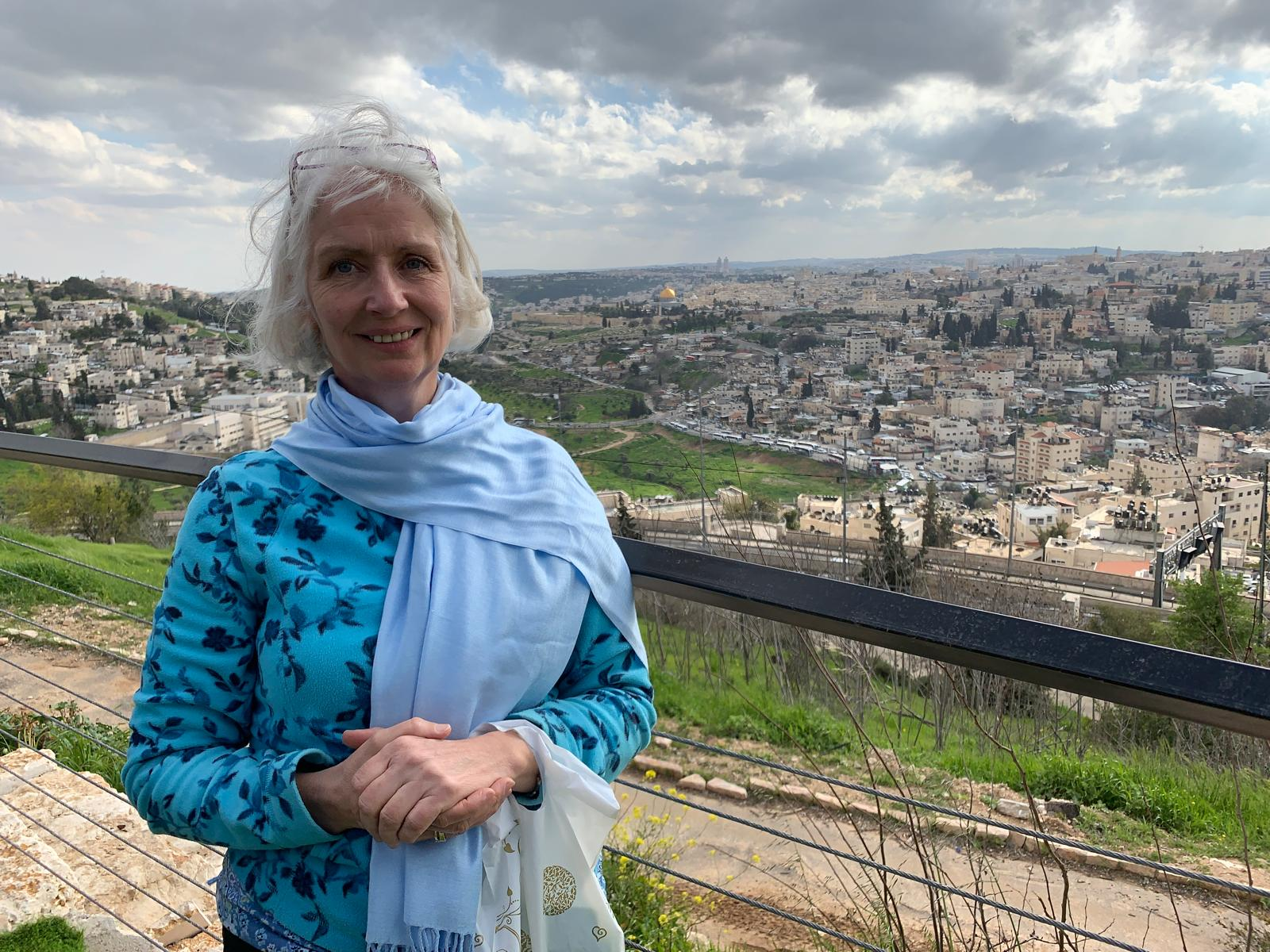 Jill Baker standing above Jerusalem, the old city spread out behind her.