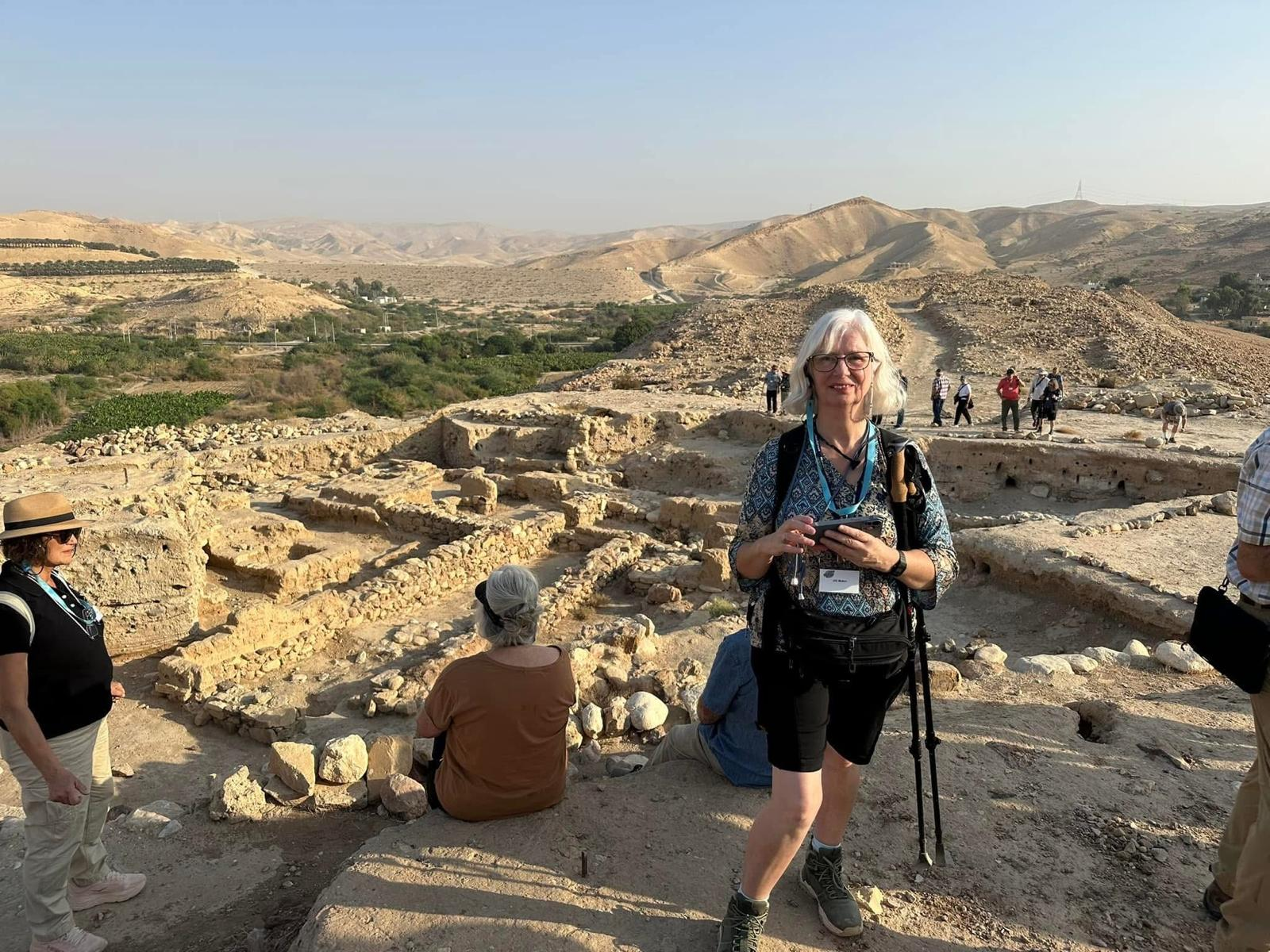 Jill Baker exploring a rock-cut tunnel on a study trip in the biblical lands.